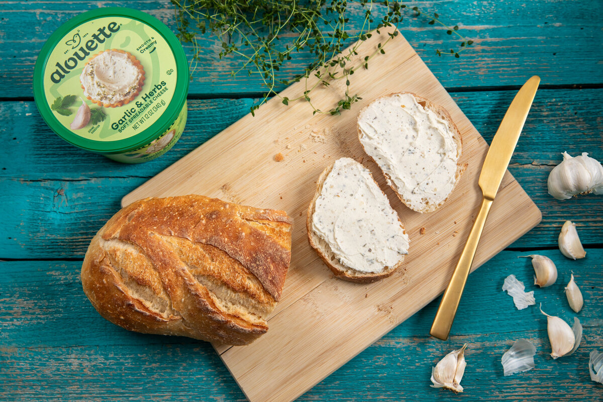 sourdough toast with alouette garlic and herb cheese spread.