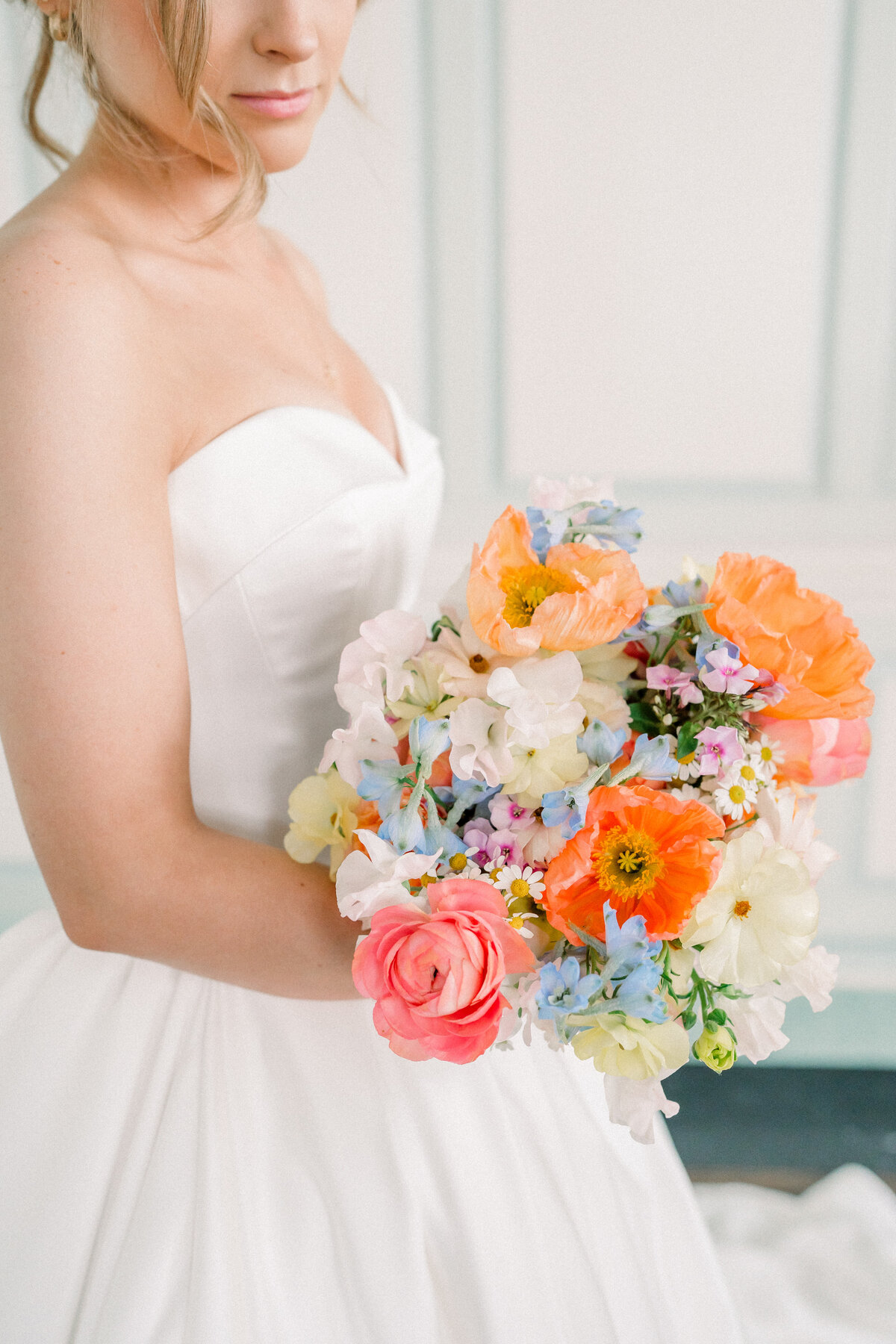 bride holding her gorgeous colorful bouquet of flowers