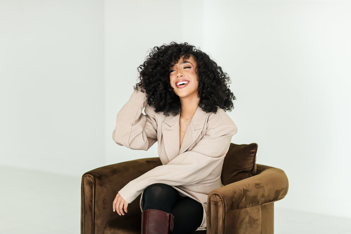Model laughing in chair