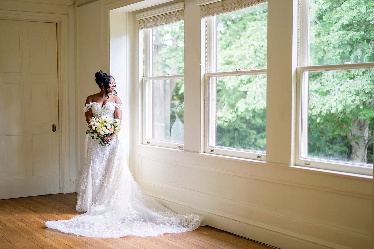 Callanwolde-Fine-Arts-Center-bride-in-dress-by-window