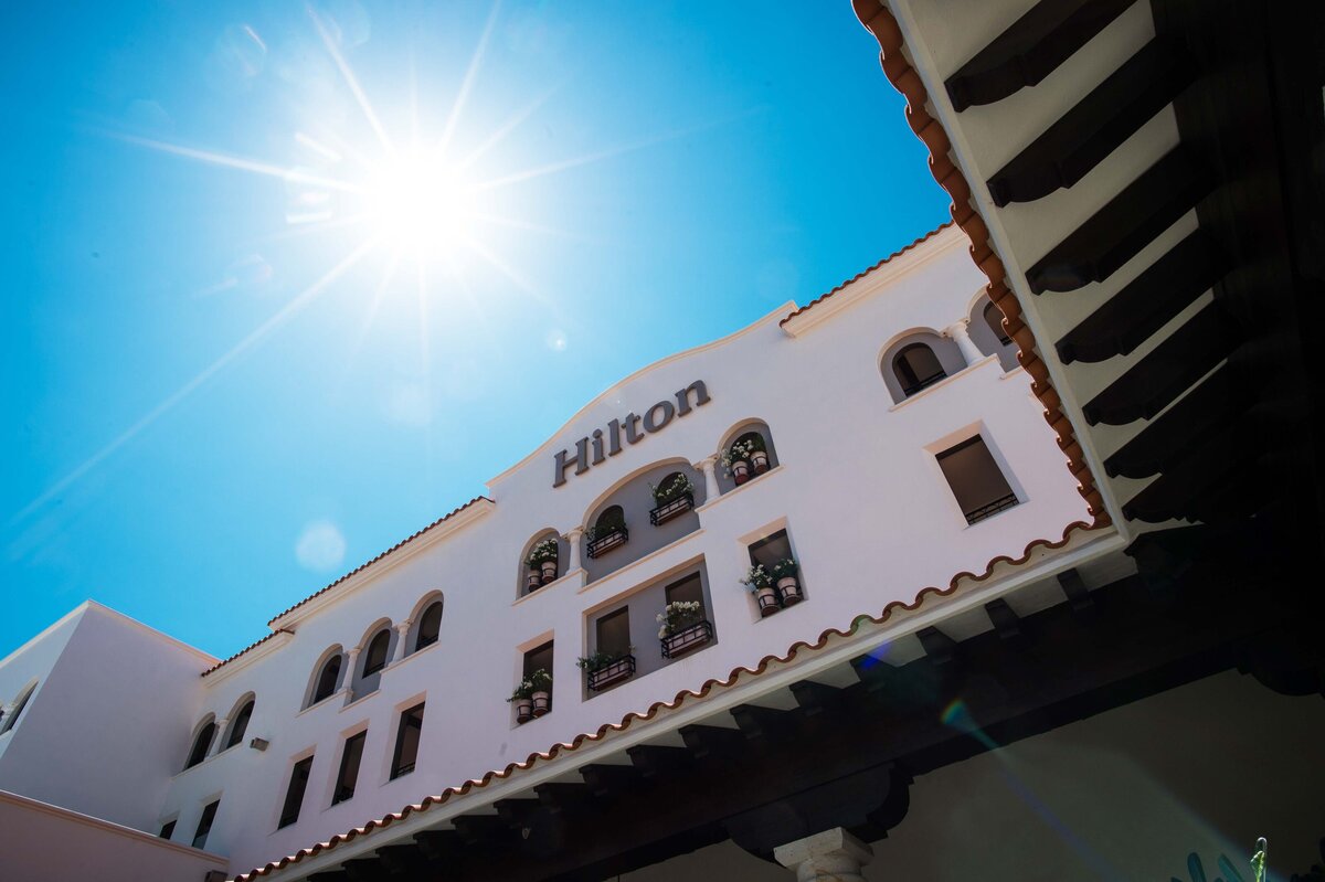 The Hilton Resort logo is shot while looking up to show  the expansiveness and weather