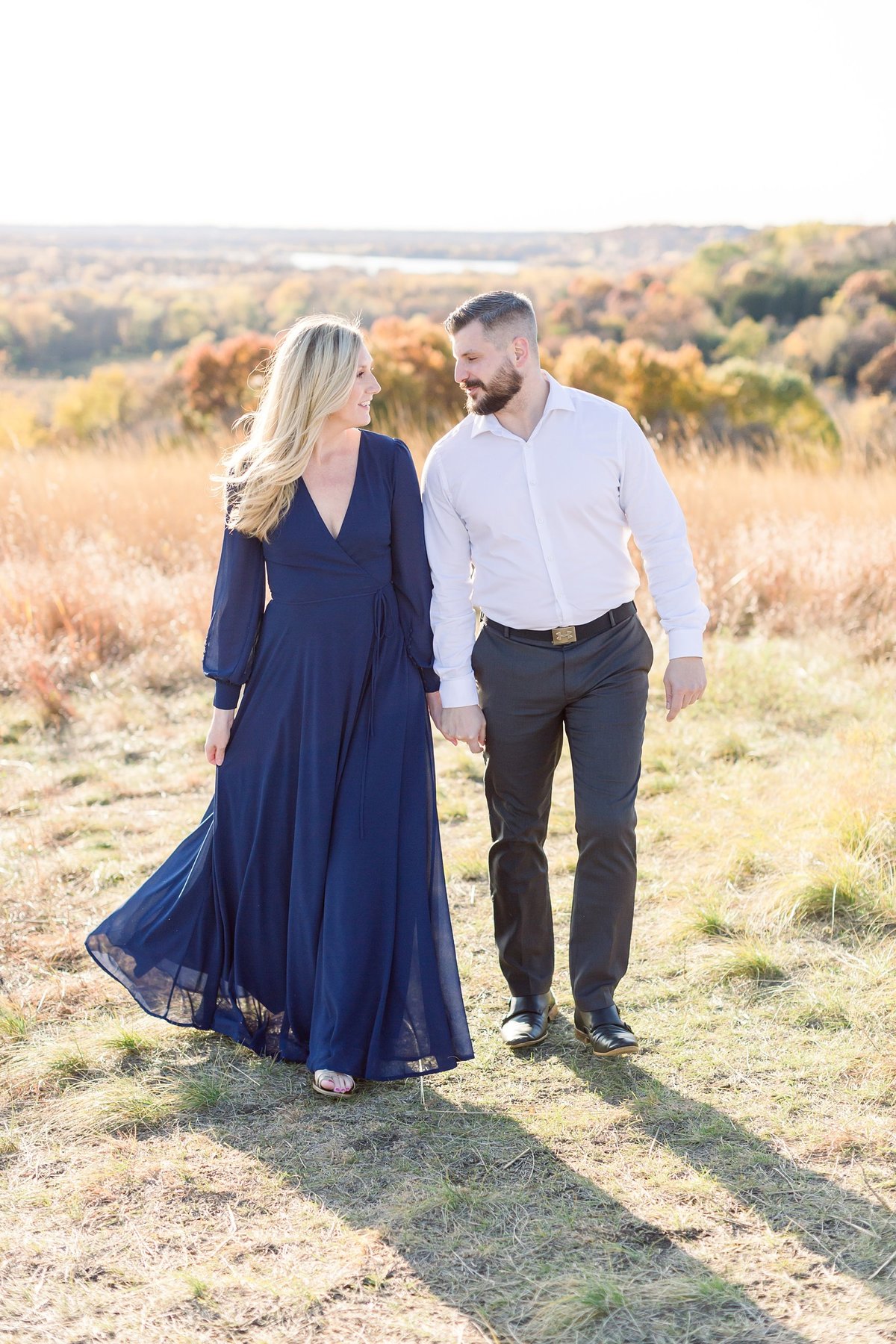 A beautiful couple candid in Eden prarie bluffs fall engagement captured by Alexandra Robyn