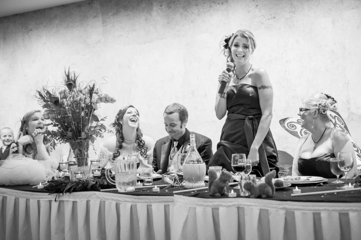 Wedding Reception Toast. Bride and Groom Laughing. Black and White. Located in Quitman Texas. Serving East Texas.