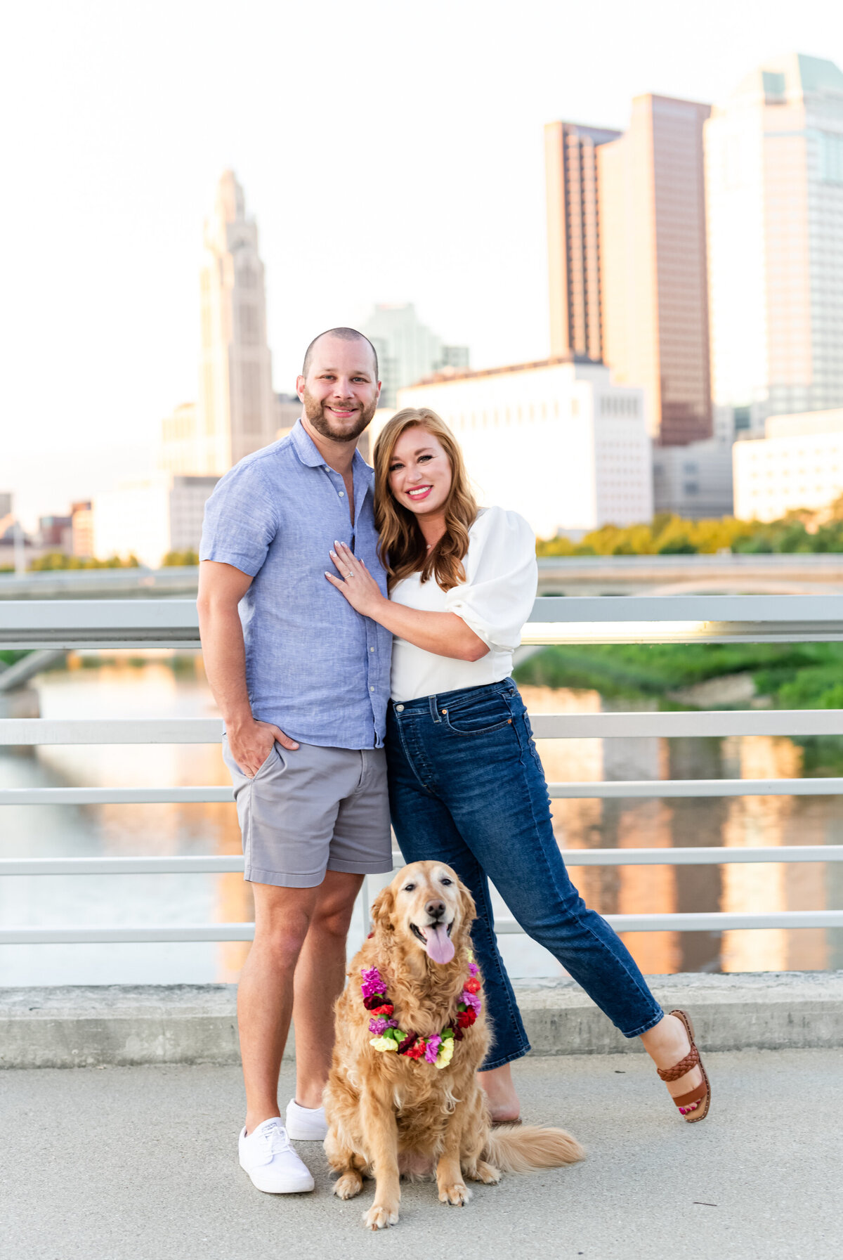 man and woman with dog on bridge