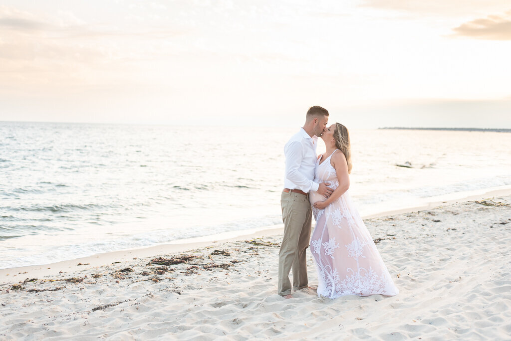 Couple kissing on beach at sunset maternity session |Sharon Leger Photography || Canton, CT || Family & Newborn Photographer