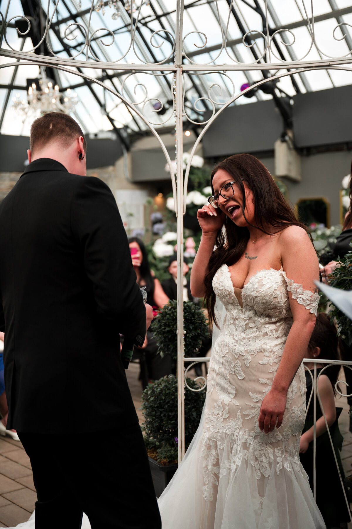 bride tears up during grooms romantic vows at greenhouse wedding ceremony, at the Muttart Conservatory in Edmonton, Alberta