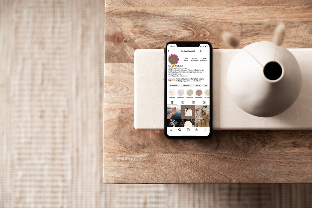iPhone on table showcasing Key is in the Details Instagram