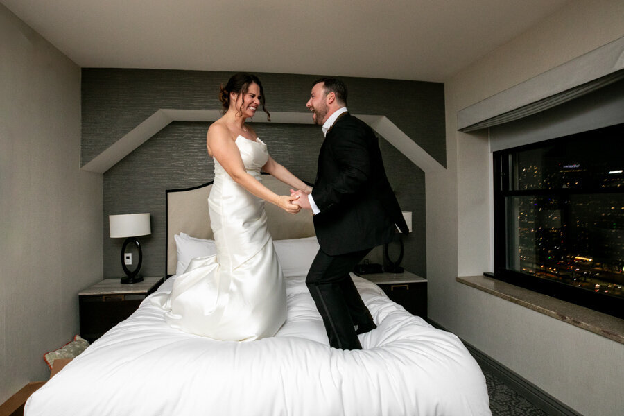 newlyweds-bed-jumping-intercon-hotel-chicago-hbicweddings