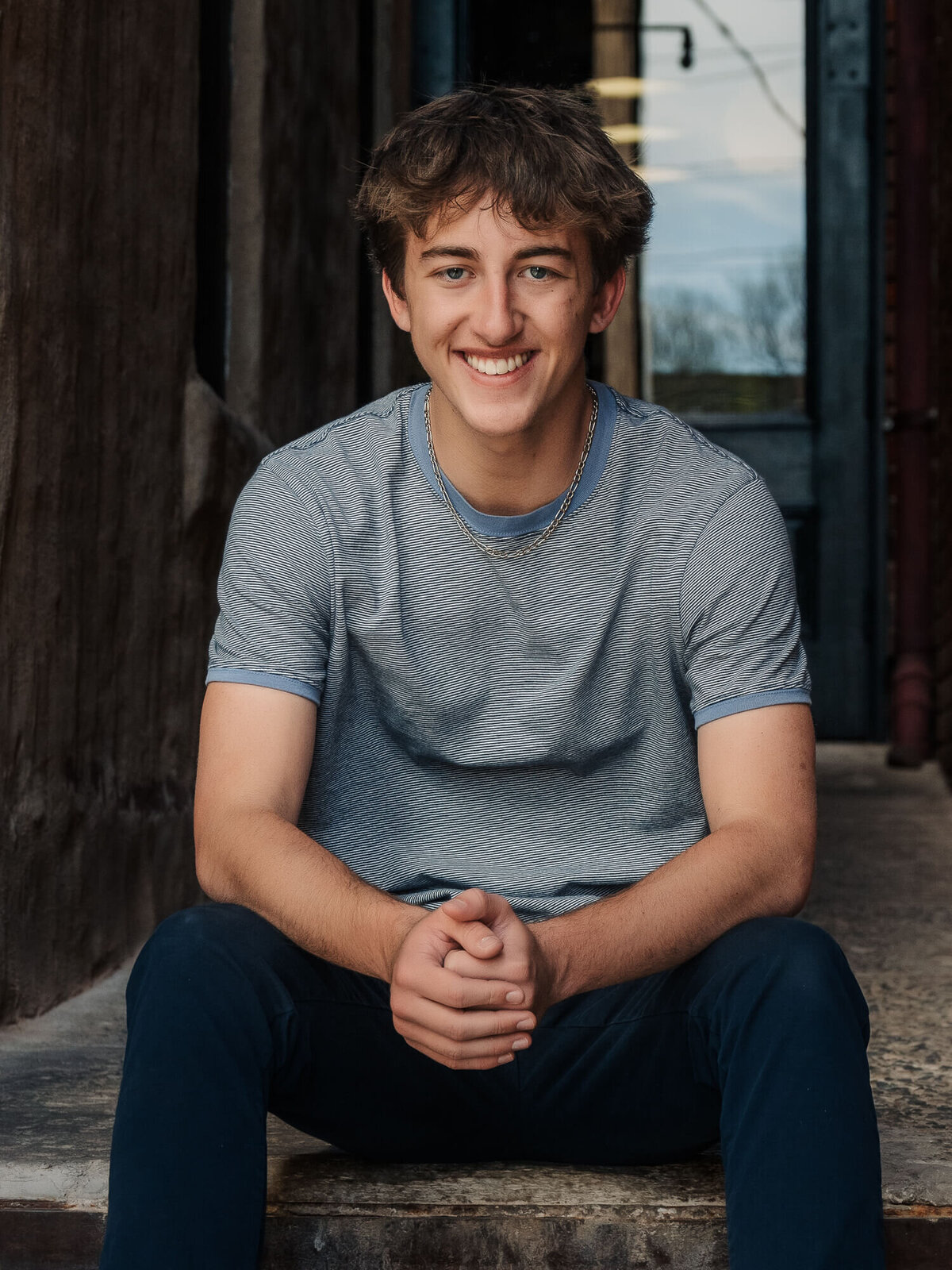Young man poses in downtown for Prescott senior photos