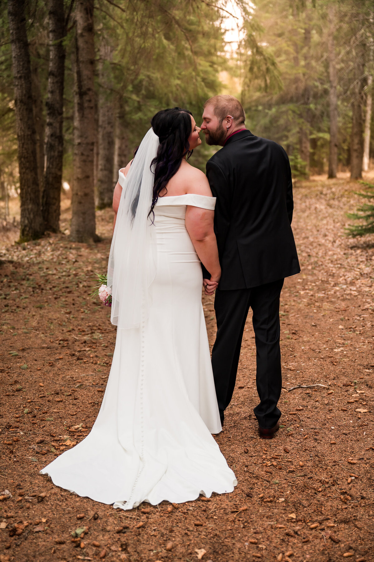 bride and groom wedding portraits taken in the forest of Rocky Mountain House., Alberta