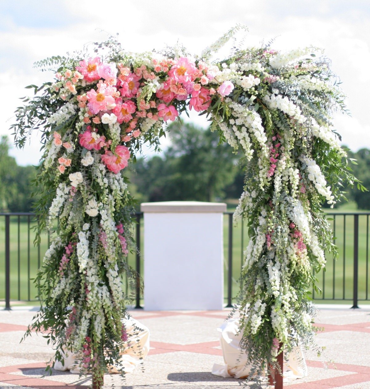 Eucalyptus wedding arch on outdoor patio at country club  by White Magnolia Designs