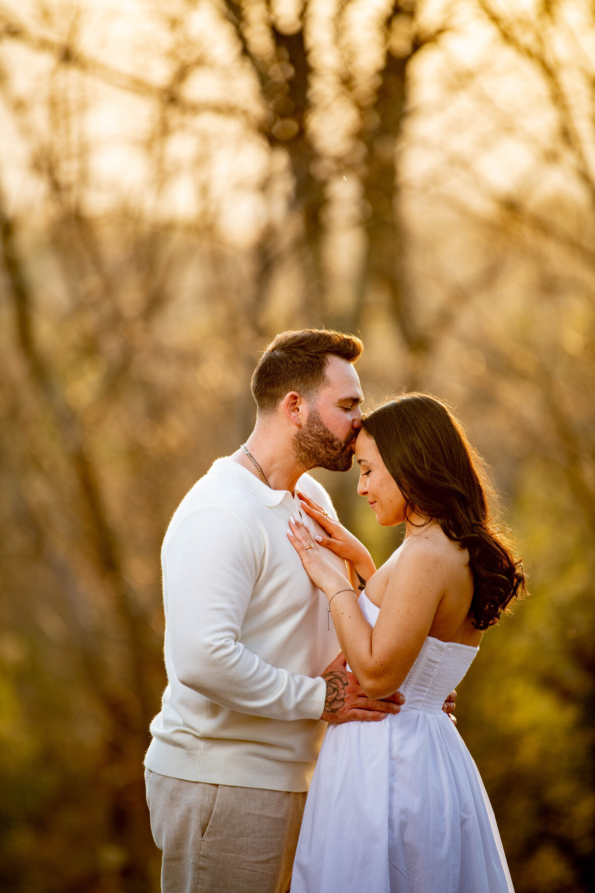 Groom kisses bride on the forehead