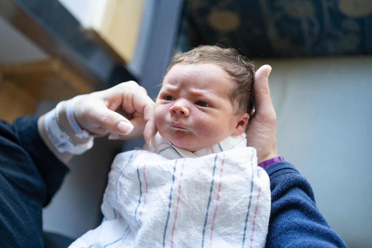 Dad holding baby in swaddle