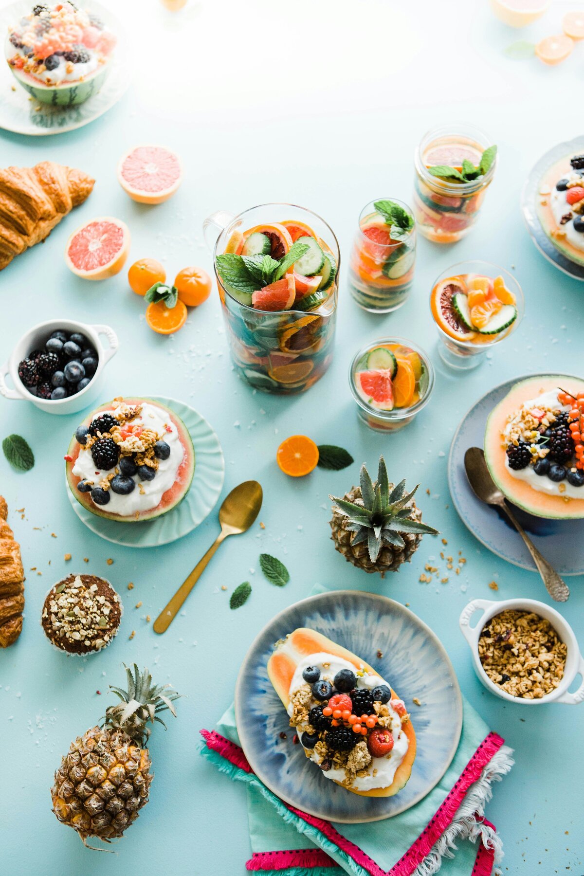 Table with a collection of fruits, yoghurts, nuts and berries