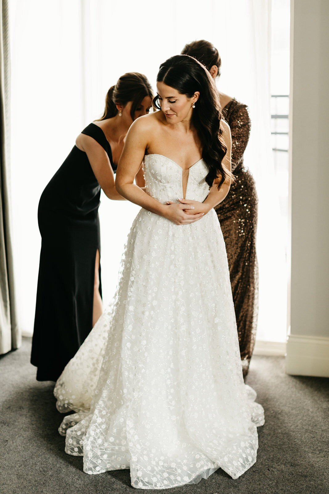 Bride putting on gown at Waldorf Chicago