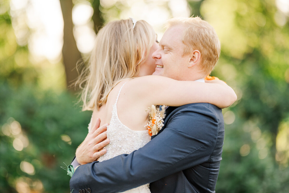 A bride and groom hug during portraits after their garden wedding in the Netherlands