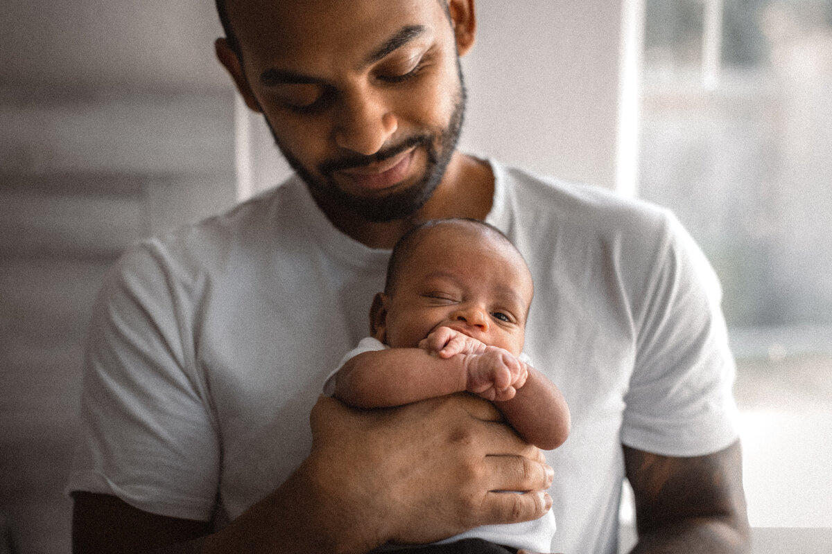 Father holding newborn baby