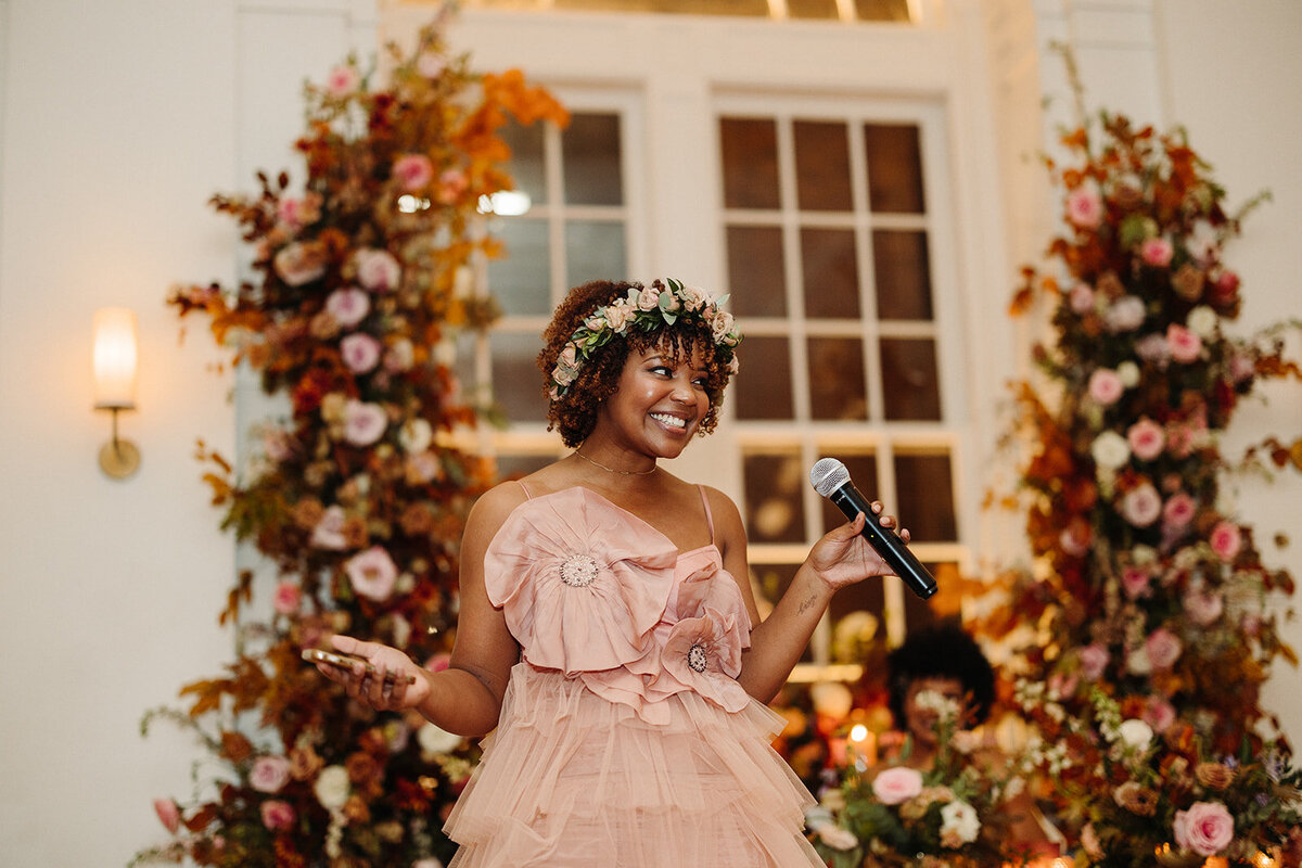 Lush growing florals surround the couple at this autumnal wedding’s sweetheart table composed of roses, ranunculus, lisianthus, dried hydrangea, delphinium, copper beech, and fall foliage creating hues of dusty rose, burgundy, mauve, copper, terra cotta, and hints of lavender. Design by Rosemary and Finch in Nashville, TN.