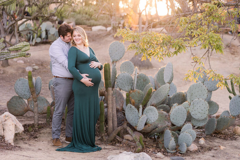 man and pregnant wife in balboa park cactus garden san diego
