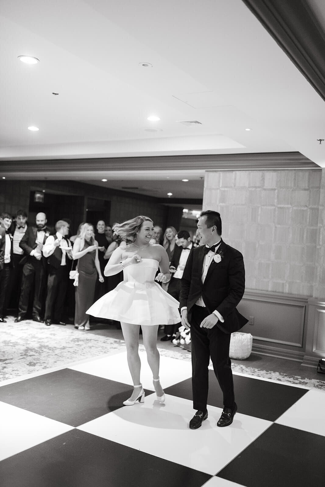 Bride and groom sharing their first dance at St. Regis Aspen, surrounded by guests in a romantic reception setting.