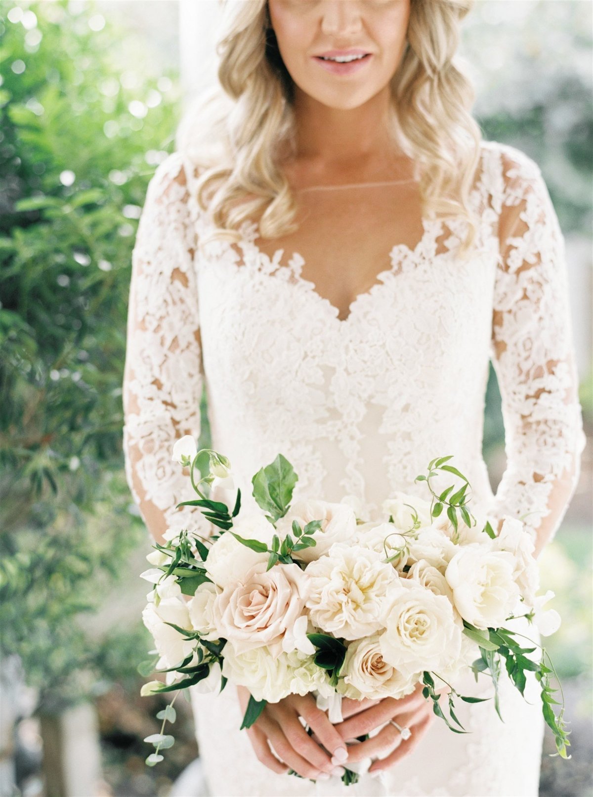 A romantic garden inspired bouquet and lace Pronovias long sleeve gown for a Cape Cod Wedding by luxury Cape Cod wedding planner and designer Always Yours Events