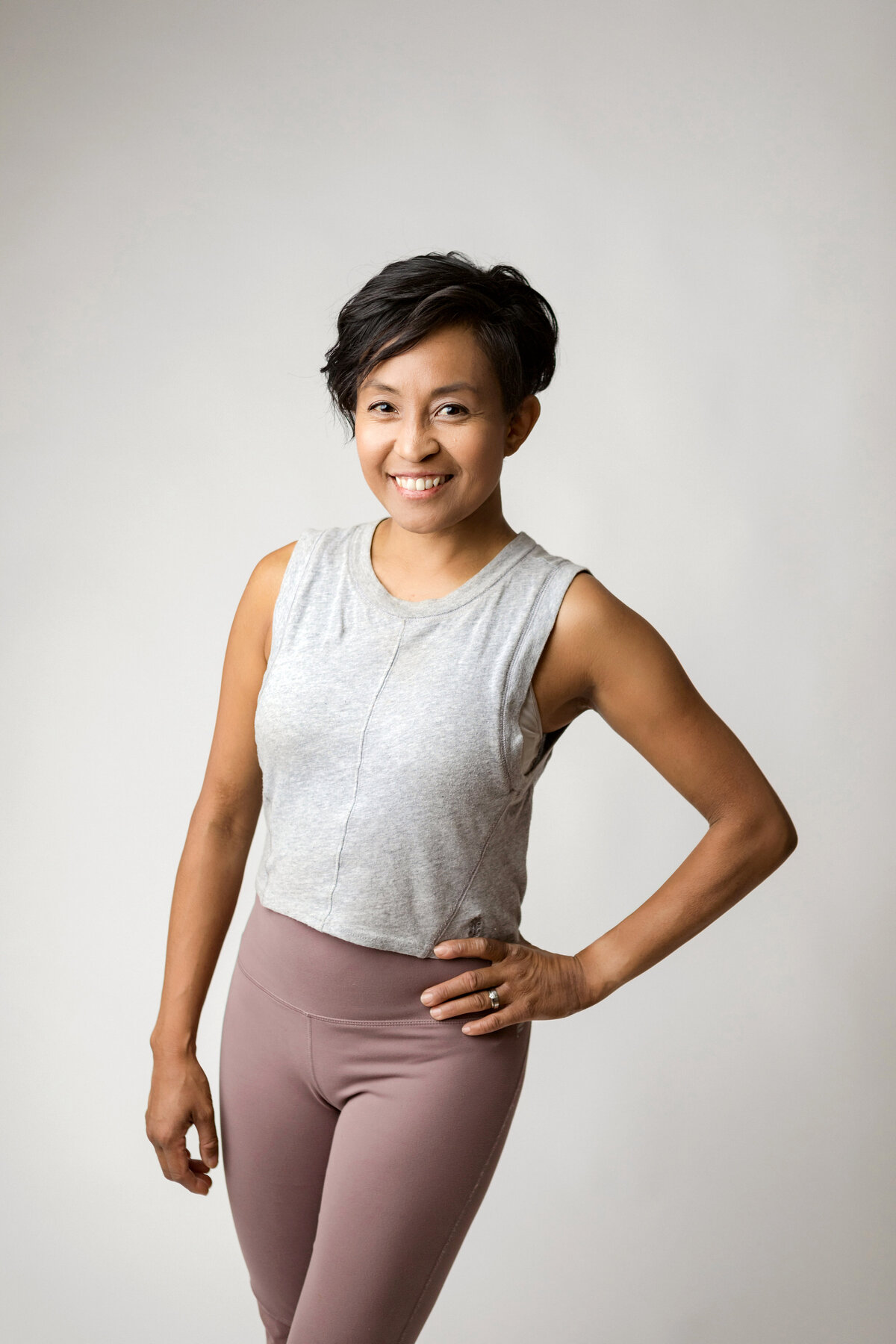 Fitness trainer smiles for brand photos