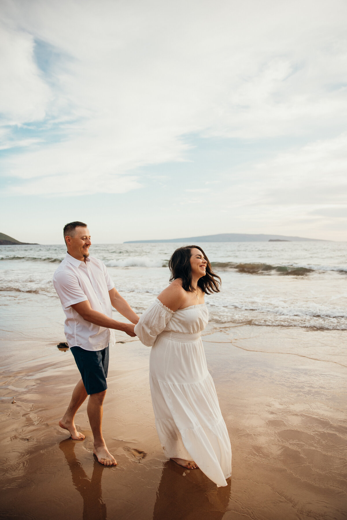Maui Couples Photographer captures couple laughing together while walking on beach