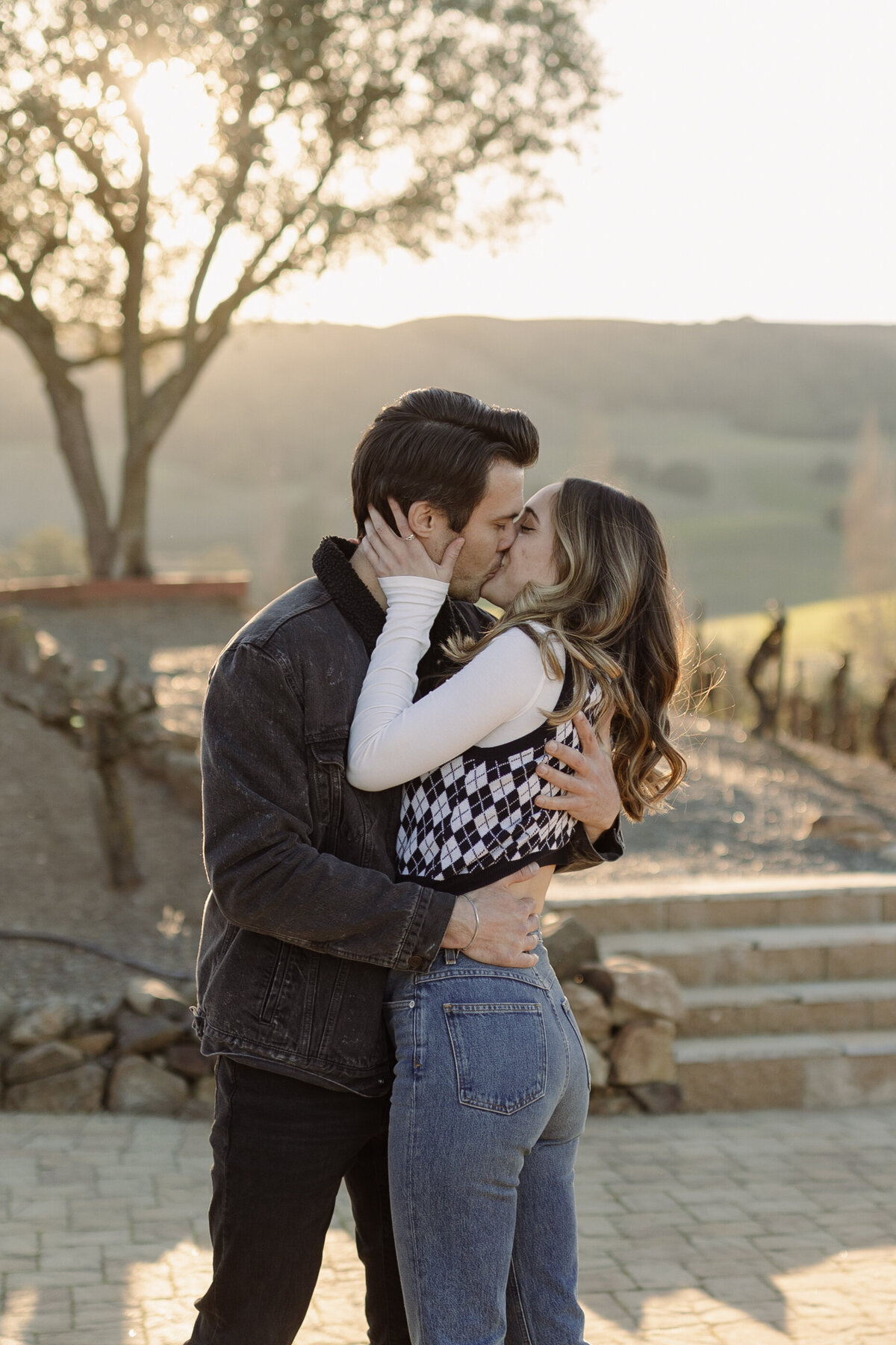 woman holding and kissing a man on a path