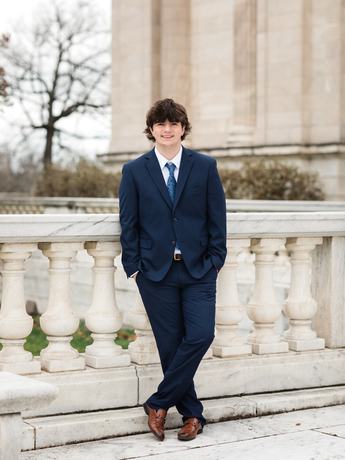 high school senior boy in blue suit posed at Cleveland Museum of Art for portraits