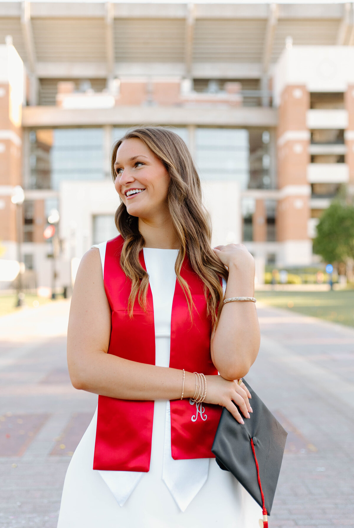 Alabama graduation picture infront of Bryant Denny Stadium
