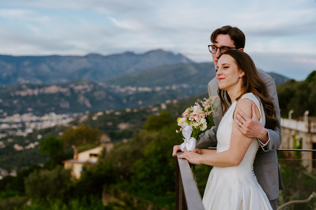 Couple hugging on Sorrento terrace at sunset