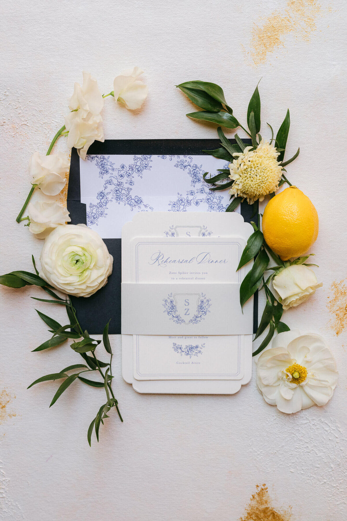 Elegant wedding invitation flat lay at Royal Palms in Scottsdale, Arizona, styled with white florals, greenery, and a lemon accent.