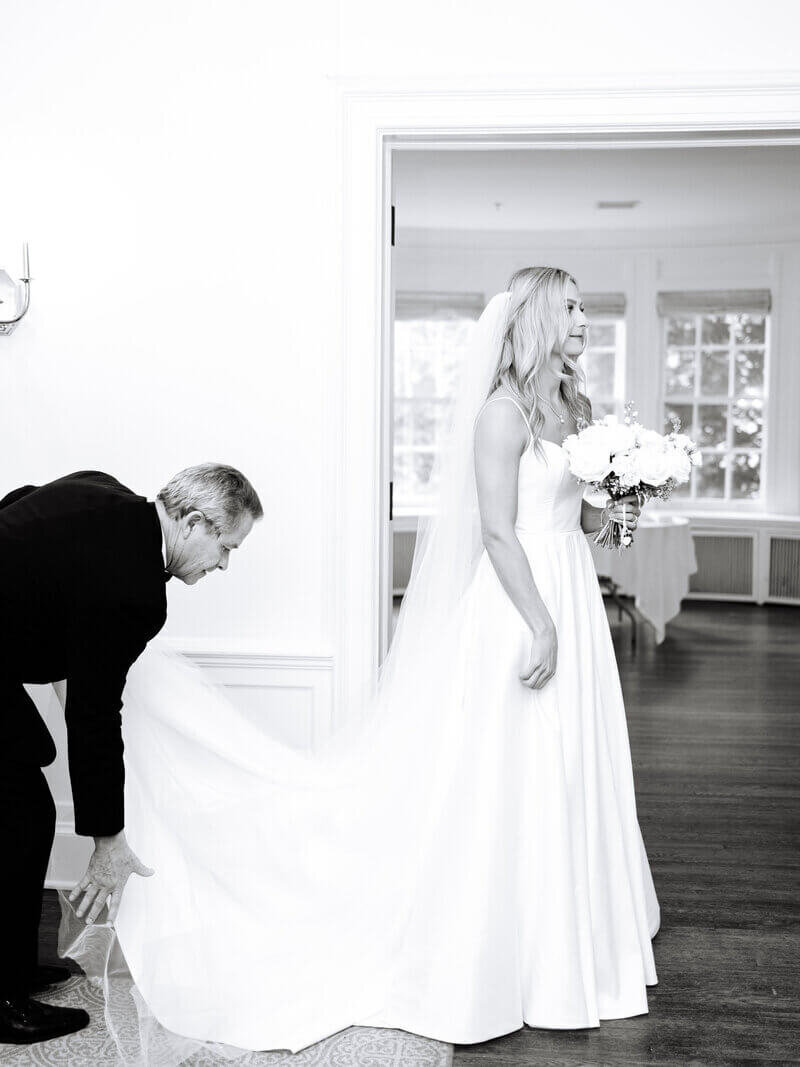 Groom holding bride's dress by chicago wedding planners