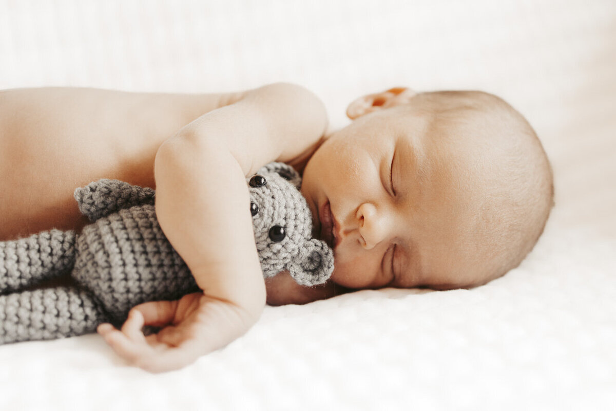 Tifton Georgia birth photography: sweet sleeping newborn holding teddy bear
