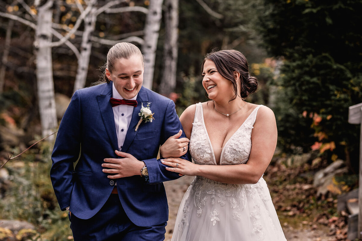 Couple walking and laughing in joyful moment in Town Square at Waterville Valley Resort wedding by Lisa Smith Photography