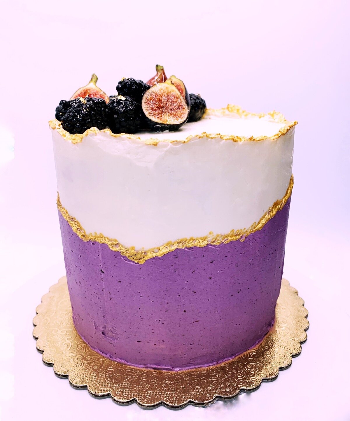 Vanilla  and blackberry buttercream cake with gold accents in Kintsugi style design. Topped with fresh figs and blackberries.