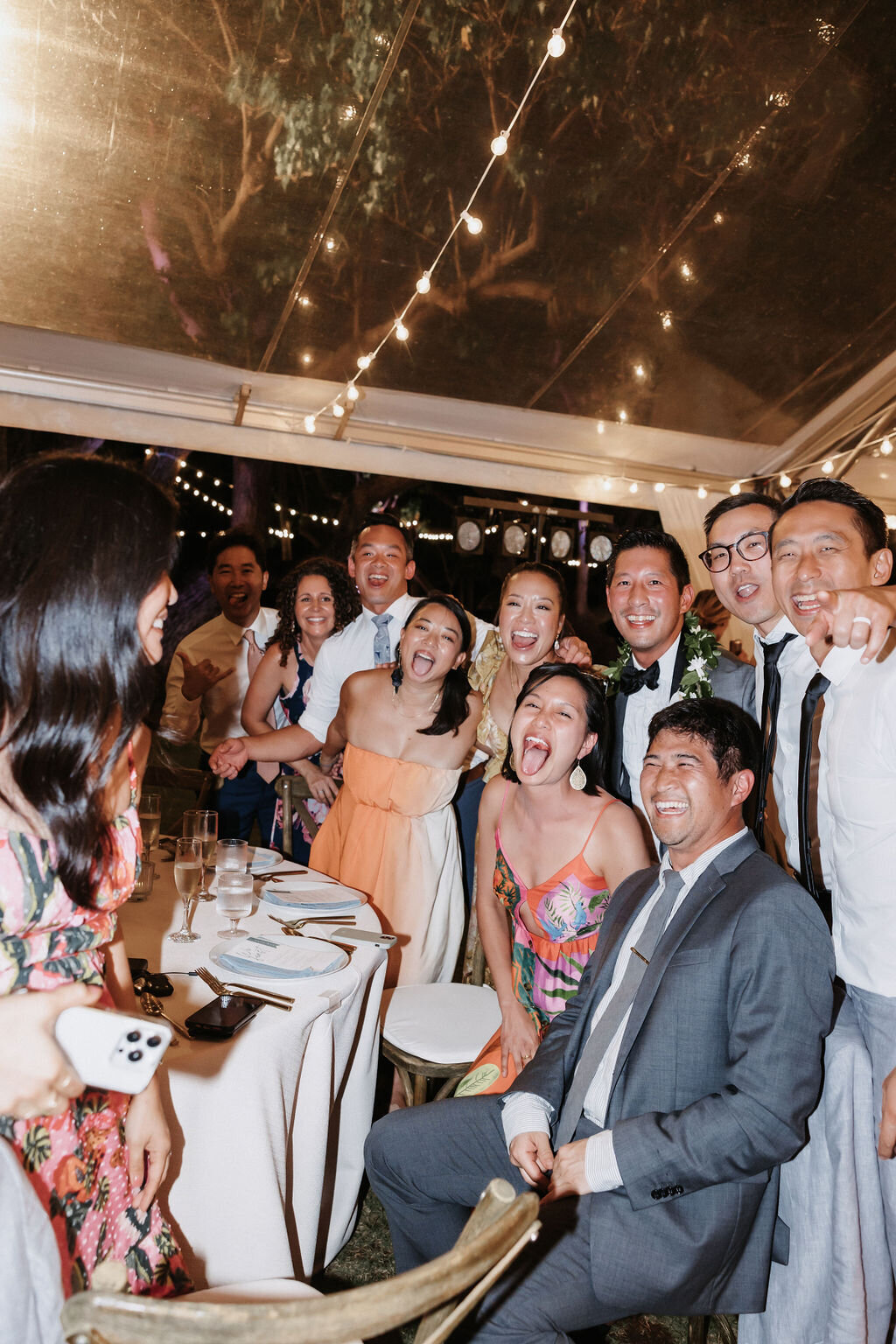 wedding guest candid photo under clear tent at lanikuhonua