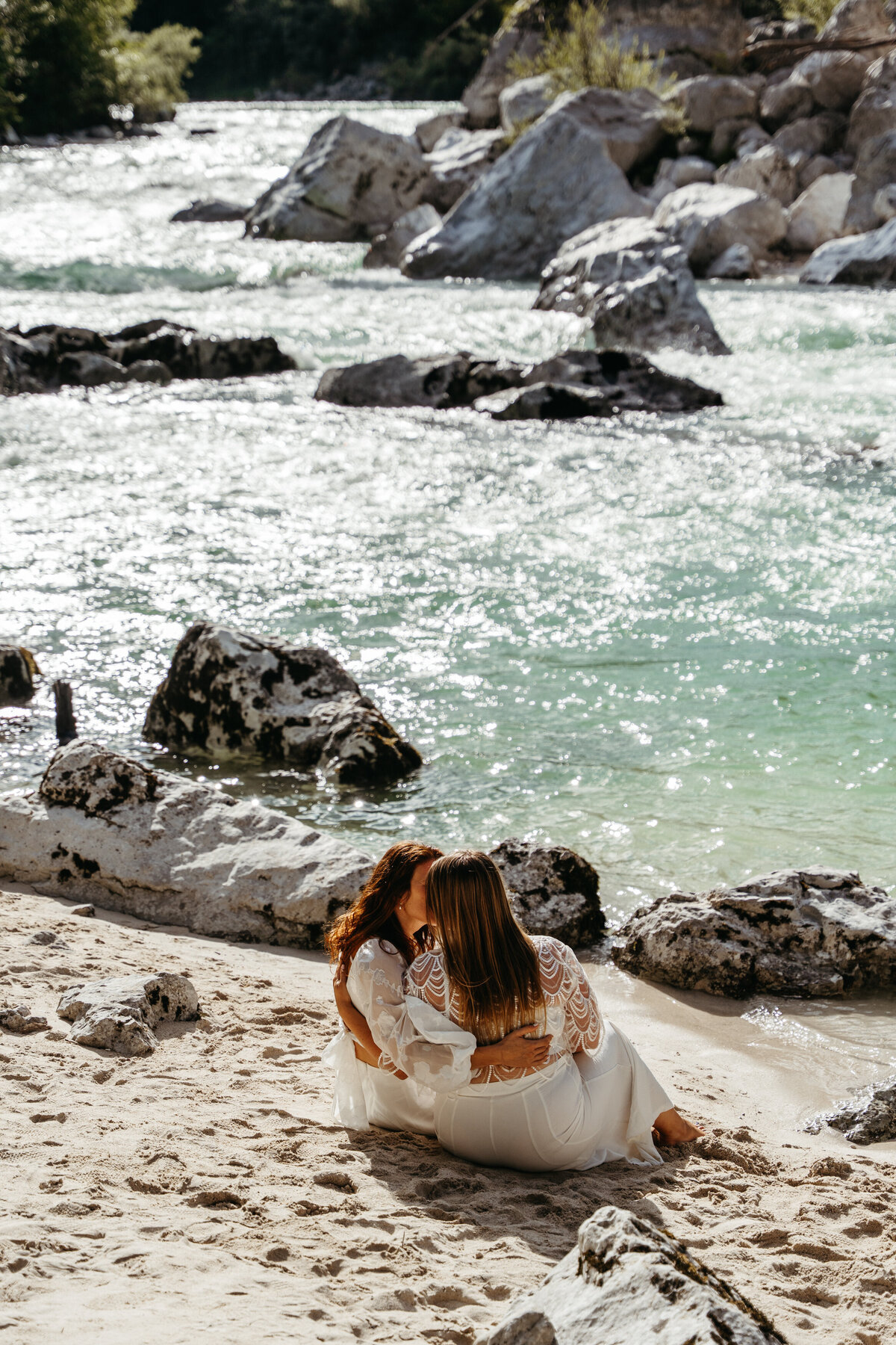 Romantic kiss in forest by turquoise river