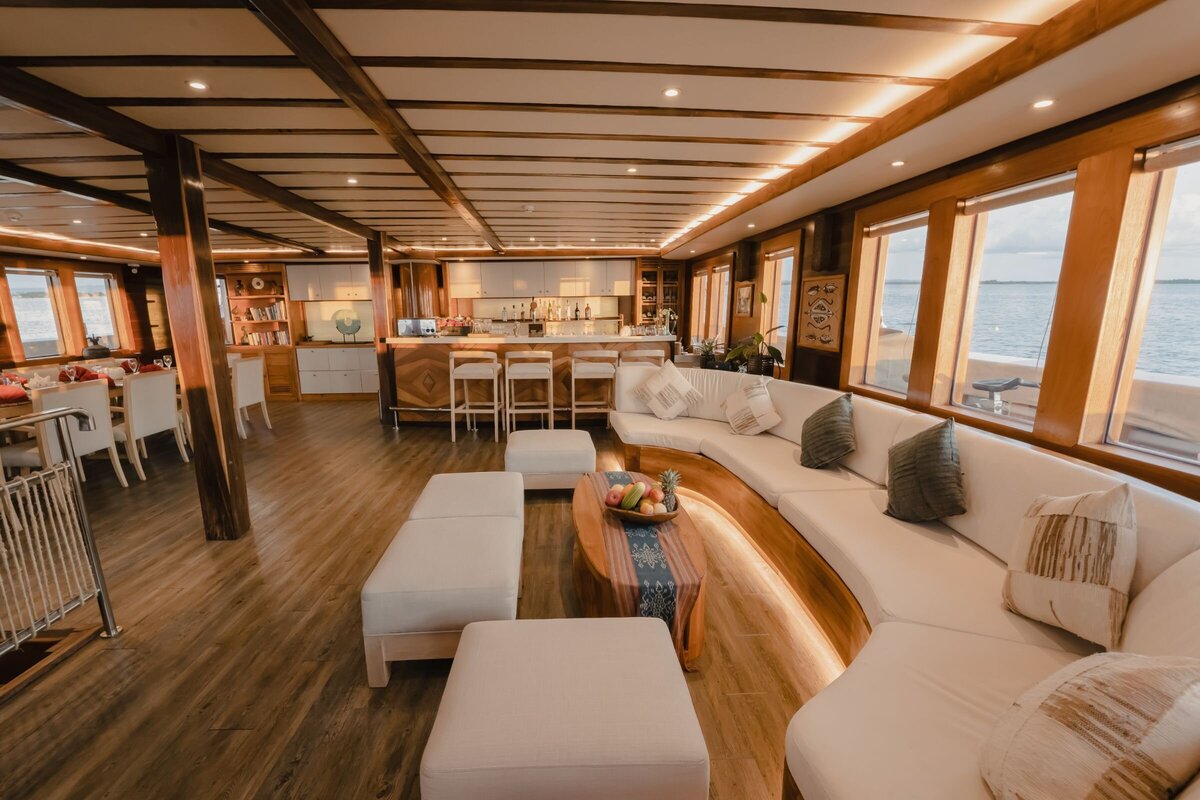 Interior salon onboard Lamima with neutral textiles and subtle LED lighting.