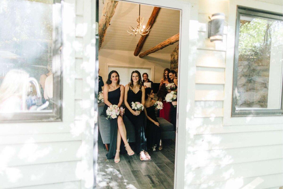 Bridesmaids Waiting in a Getting Ready Lakehouse before a Luxury Michigan Lakefront Golf Club Wedding.