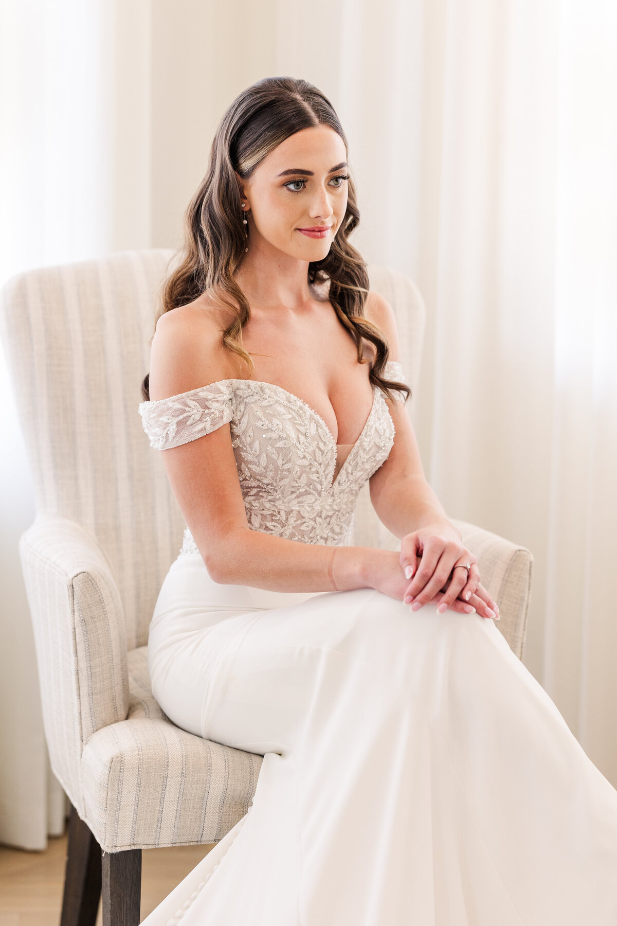 A serene bridal portrait in a bright and airy suite, captured just before the ceremony in Westlake, TX. This image offers a glimpse into timeless wedding moments across the Dallas-Fort Worth region.