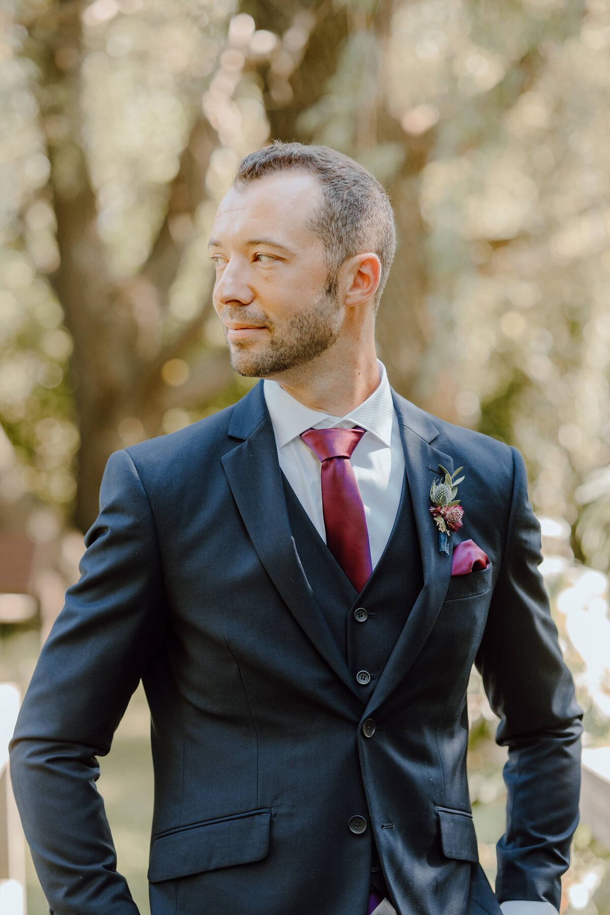 groom posing in navy suit