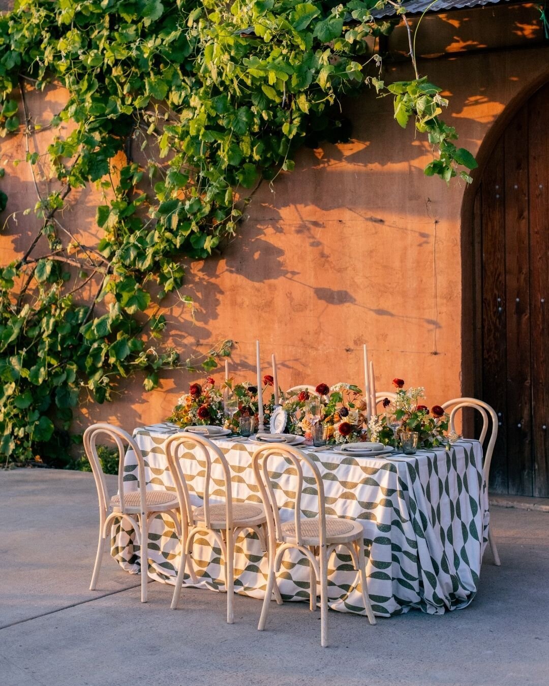 A romantic table setting adorned with soft candlelight and delicate floral accents.