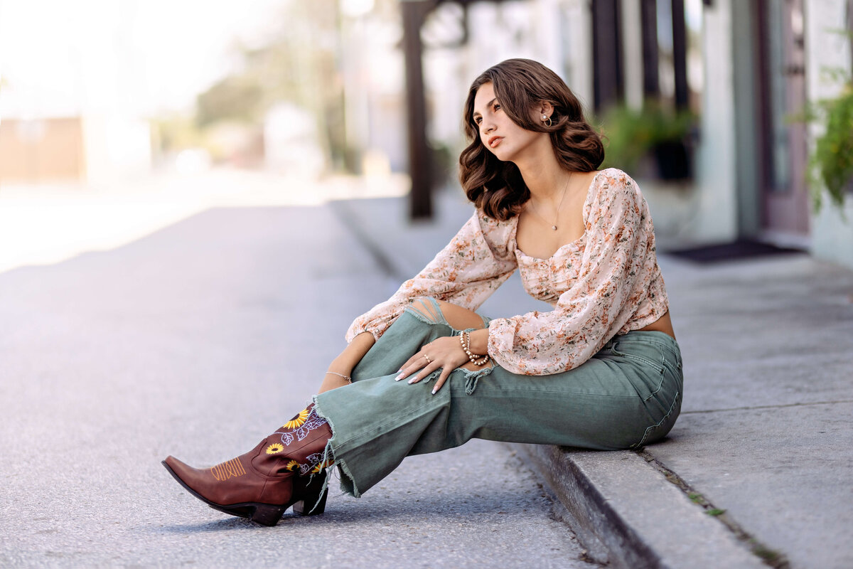 Editorial portrait with urban tones and serious expression near downtown architecture