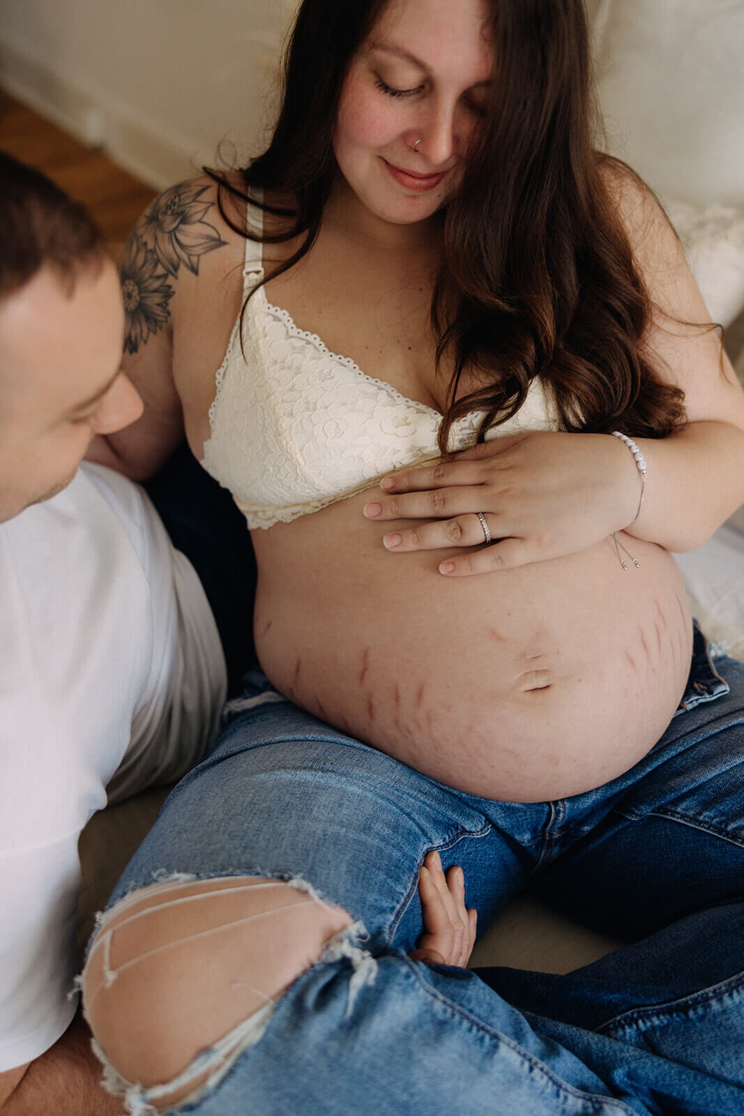 Woman with bear baby bump with man looking at it at  Finger Lakes Maternity session