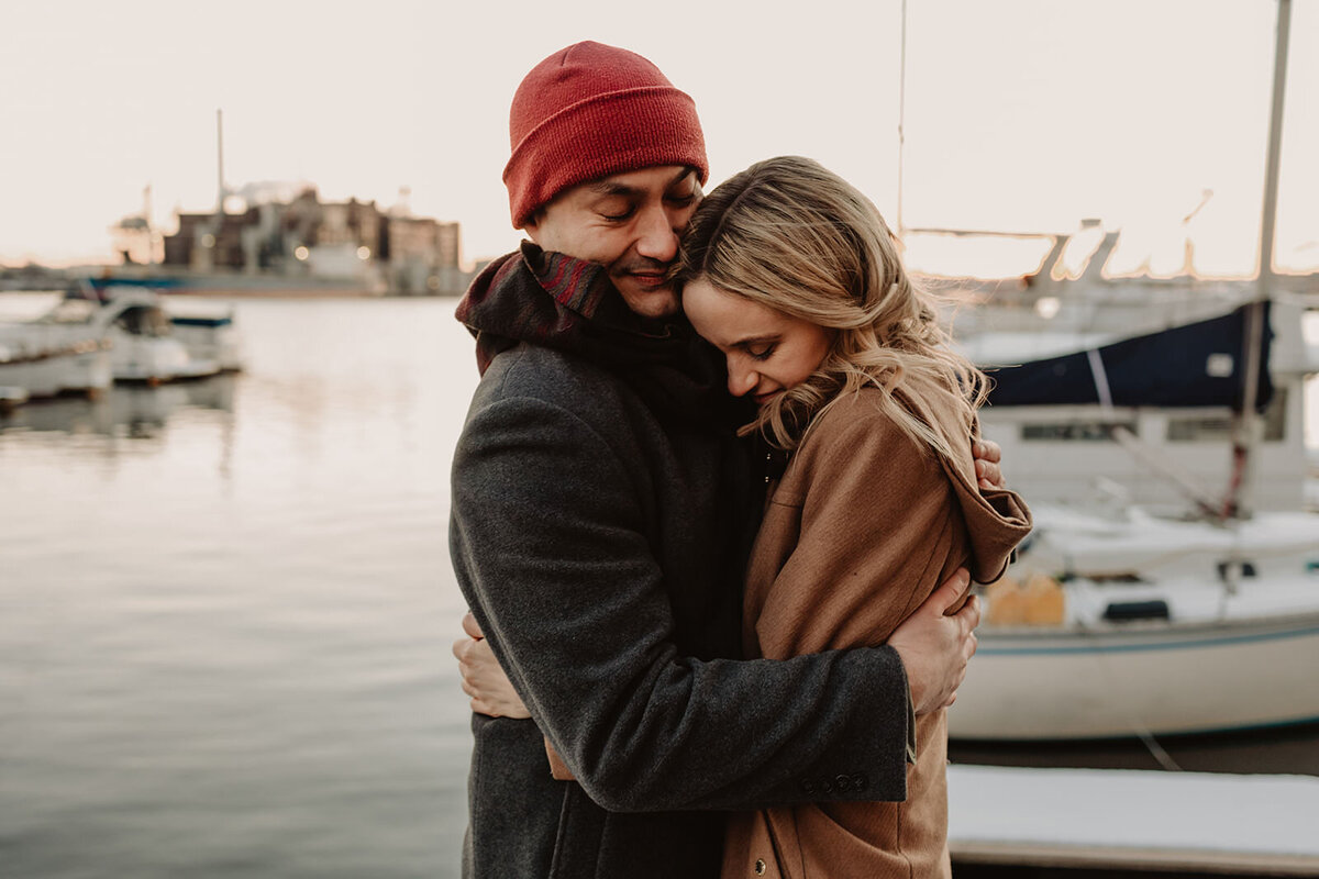 A couple hugging on a pier 