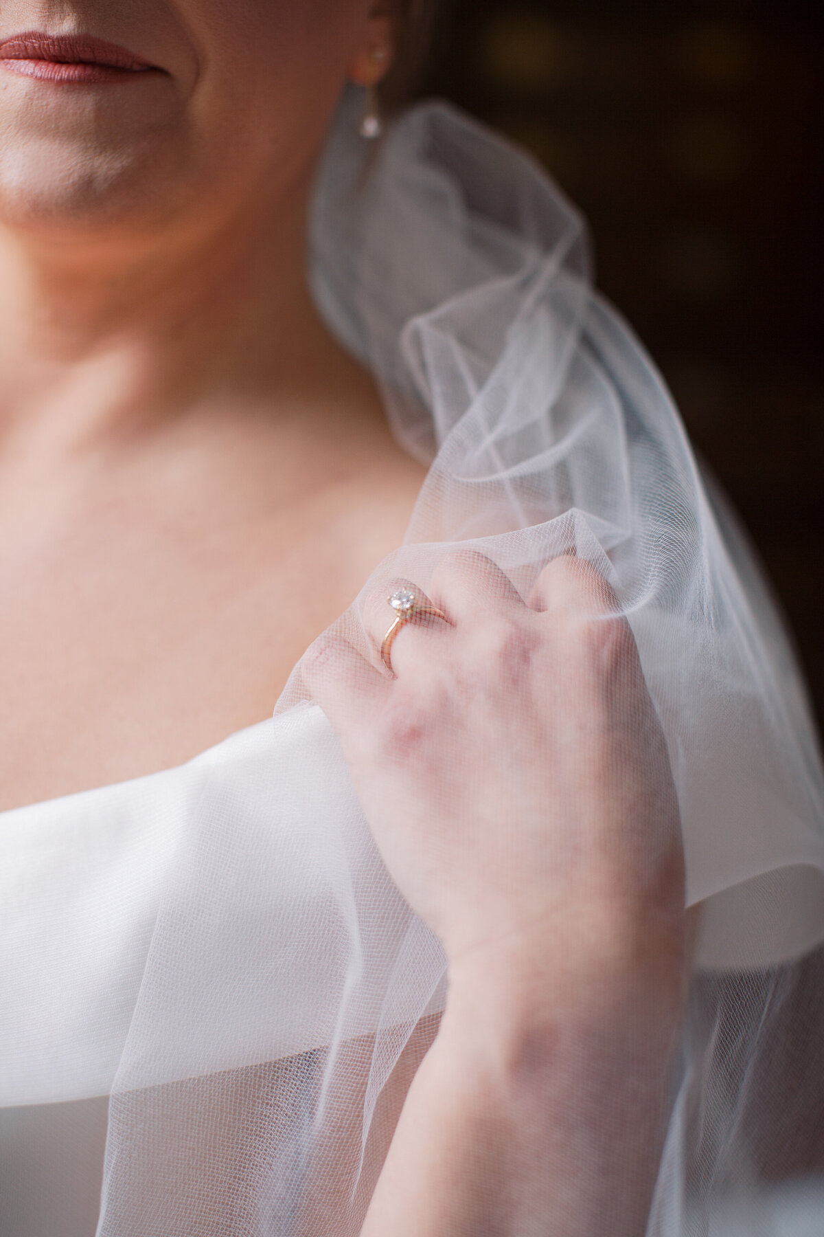 Details of bridal veil and engagement ring