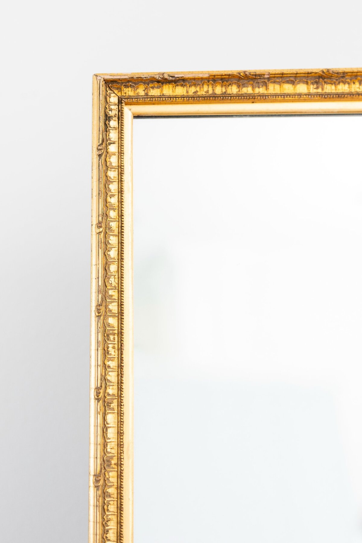 Large gold mirror with ornate border 
