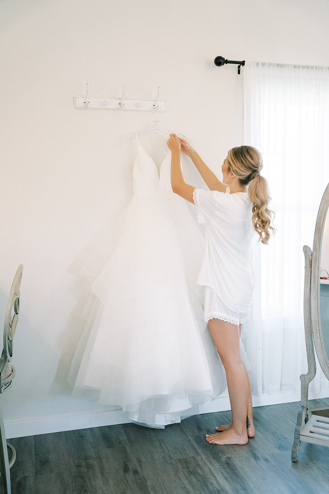 bride getting her dress off of a hanger