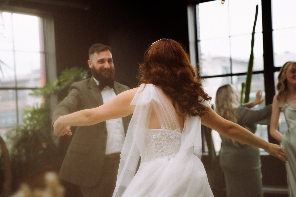 happy wedding couple dancing at reception